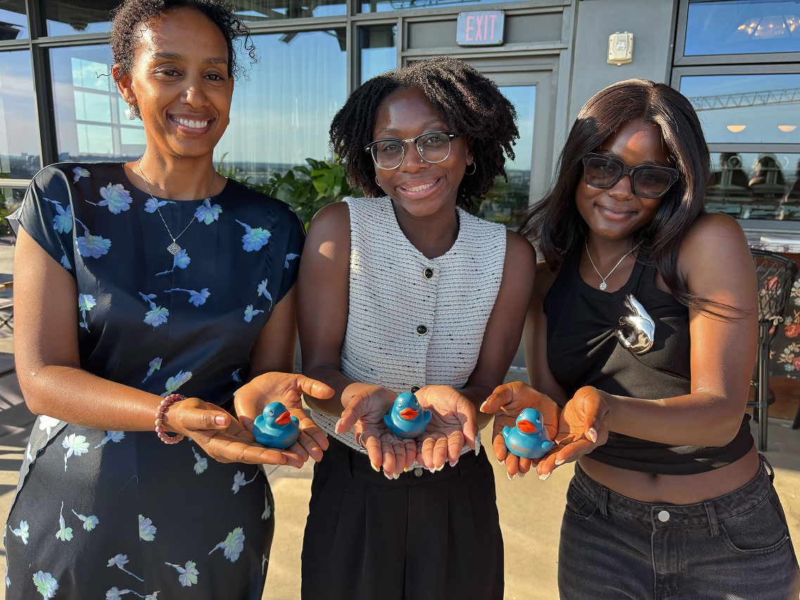 Photo of three women holding RTC rubber duckies
